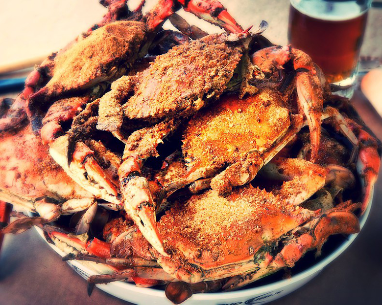 Steaming snow crab legs with Old Bay seasoning and mussels